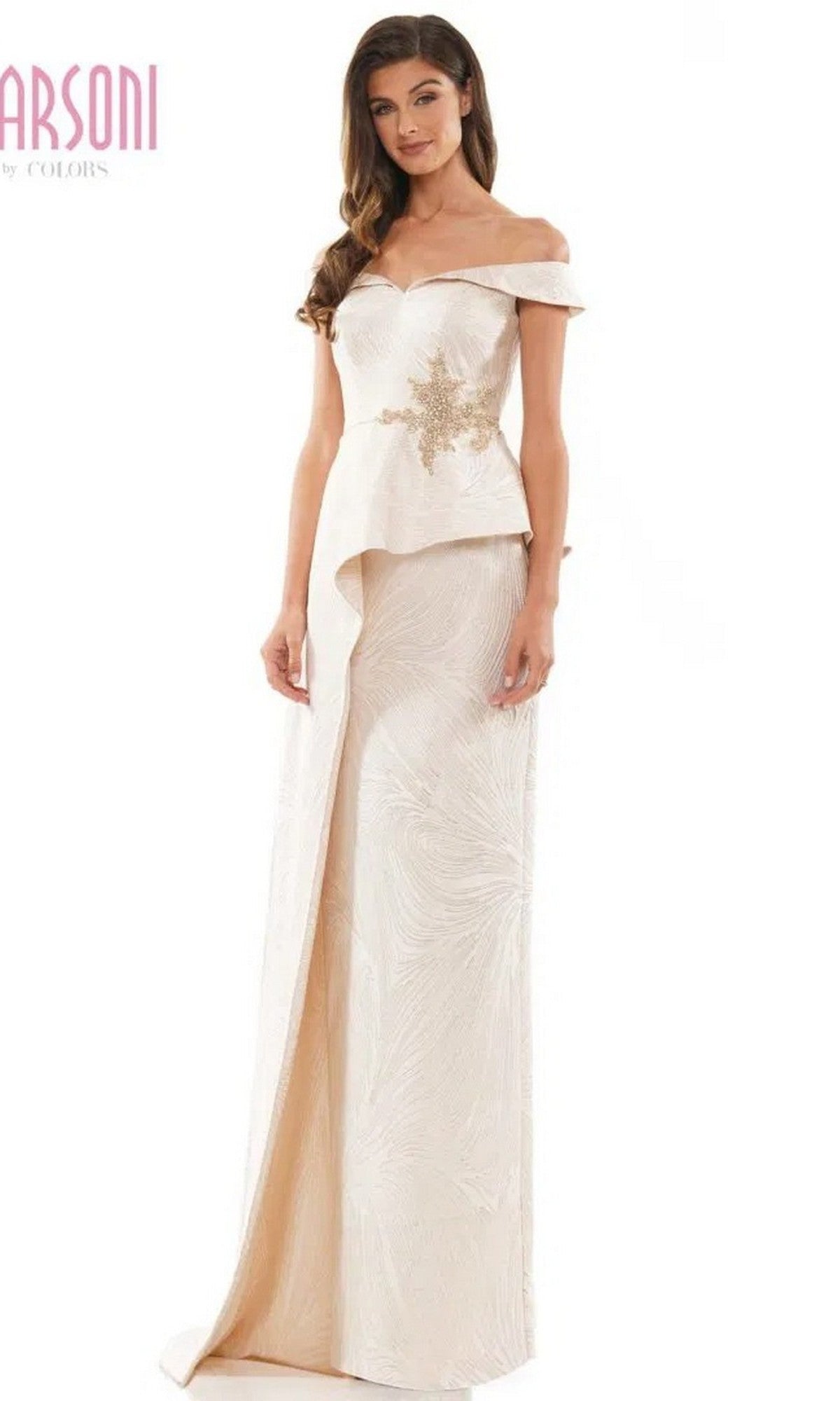 A woman wears the Marsoni MV1225 long formal dress in champagne, featuring an off-shoulder neckline, beaded bodice embellishment, and a floor-length textured jacquard skirt.